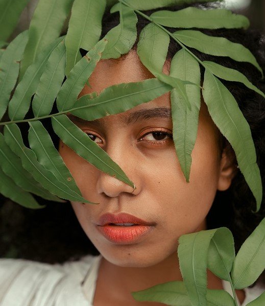 Girl's face partially obscured by fern leaves - Vickys Story