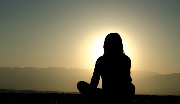 Silhouette of women looking toward sun